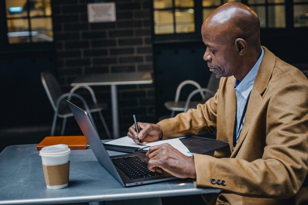concentrated black man working in cafe